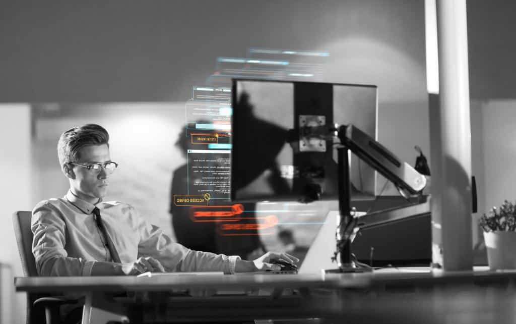 IT administrator monitoring threats on a security dashboard for a small company.